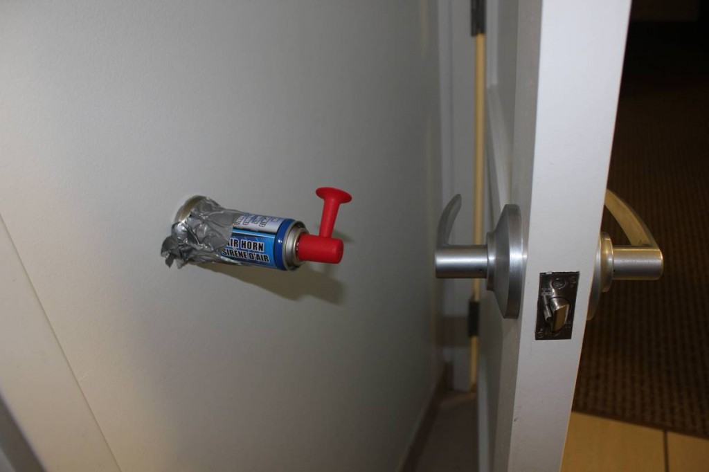 A well placed air horn behind the door